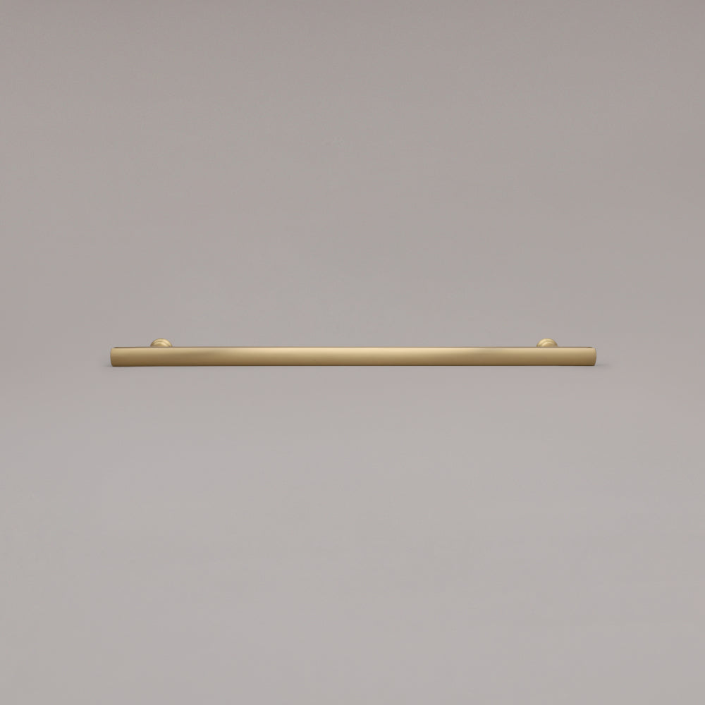 18" Mod appliance pull in Satin Brass laying on gray background