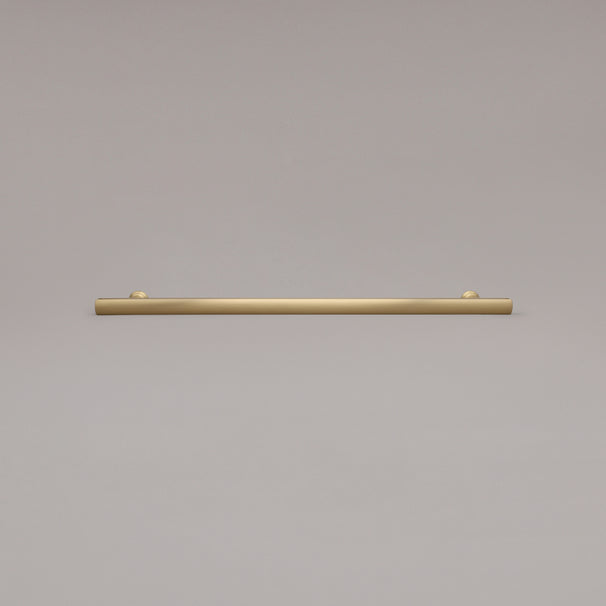 18" Mod appliance pull in Satin Brass laying on gray background