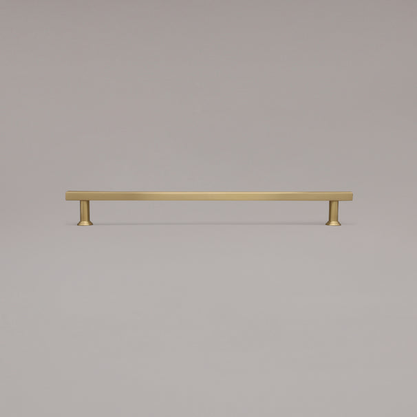 18" Mod appliance pull in Satin Brass standing on gray background