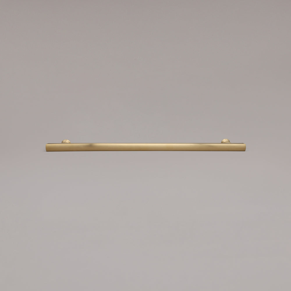 18" Mod appliance pull in Unlacquered Satin Brass laying on gray background