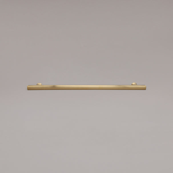 18" Mod appliance pull in Unlacquered Satin Brass laying on gray background