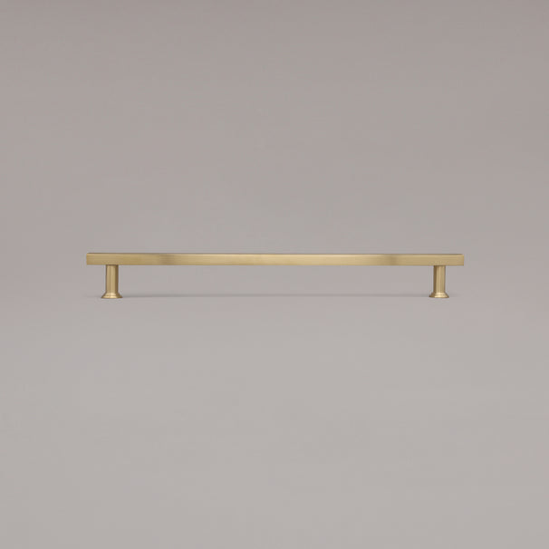 18" Mod appliance pull in Unlacquered Satin Brass standing on gray background