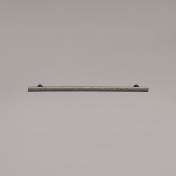 18" Mod appliance pull in Weathered Nickel and Matte Black laying on gray background
