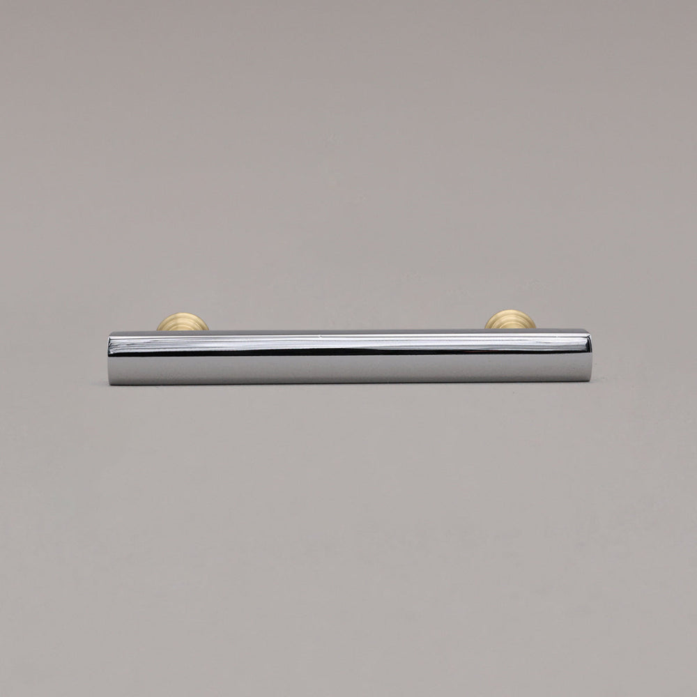 polished chrome and satin brass mod pull laying on gray background