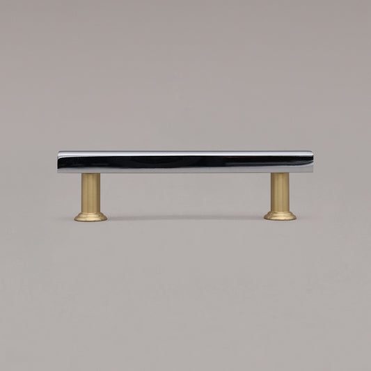 black and satin brass mod cabinet pull standing on gray background