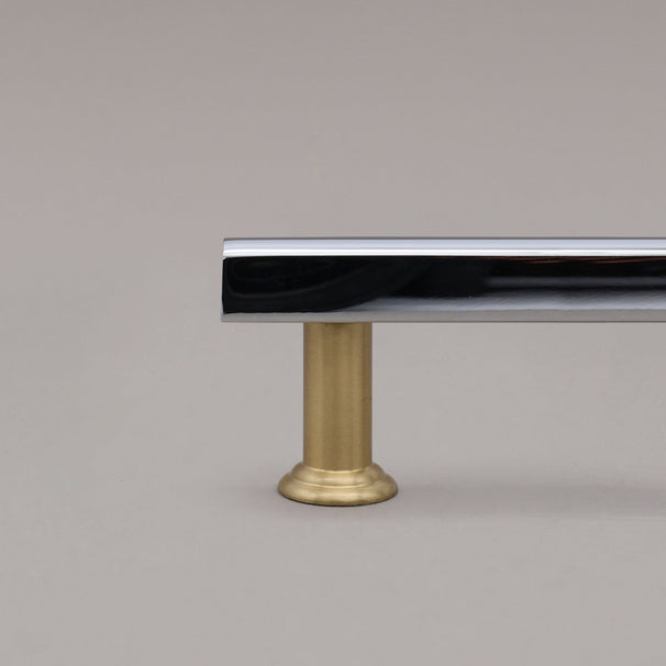 polished chrome and satin brass mod cabinet pull close up on stem 