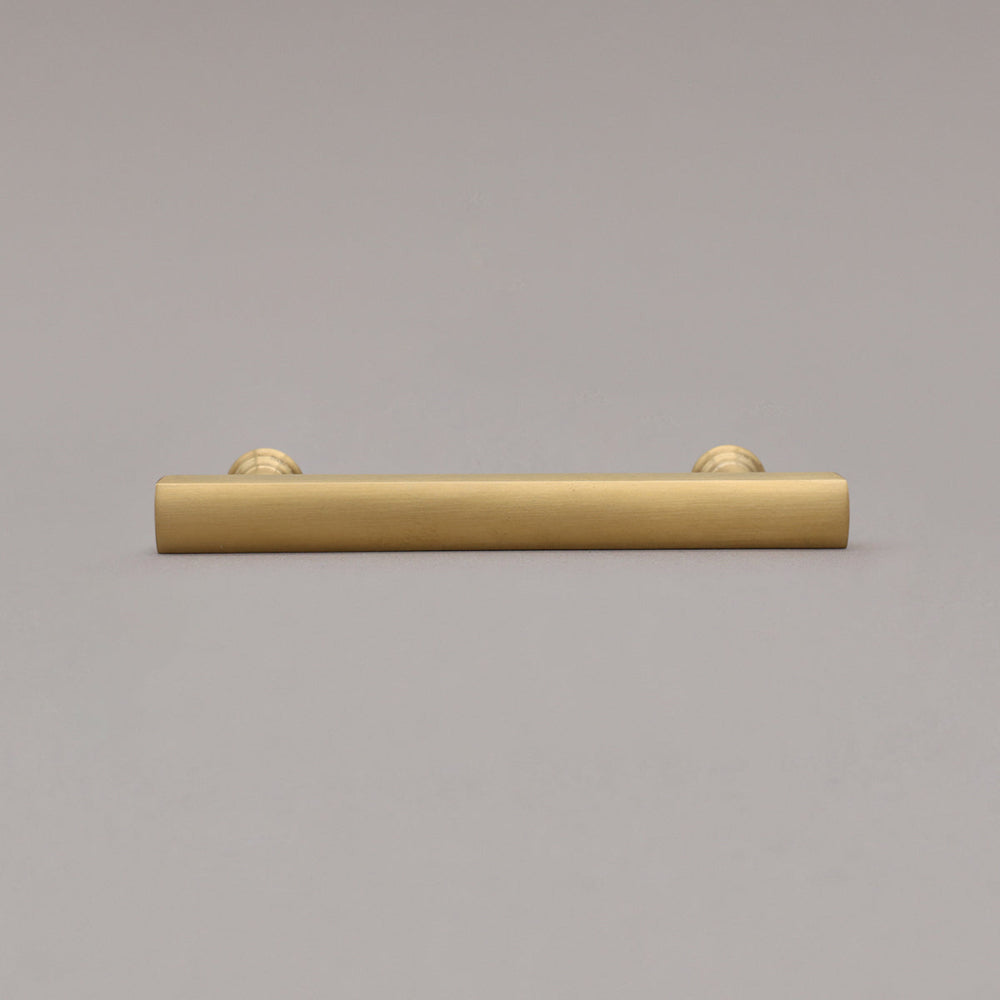 unlacquered satin brass mod pull laying on gray background