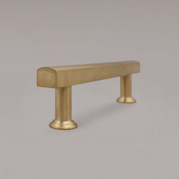unlacquered satin brass mod pull side view standing on gray background