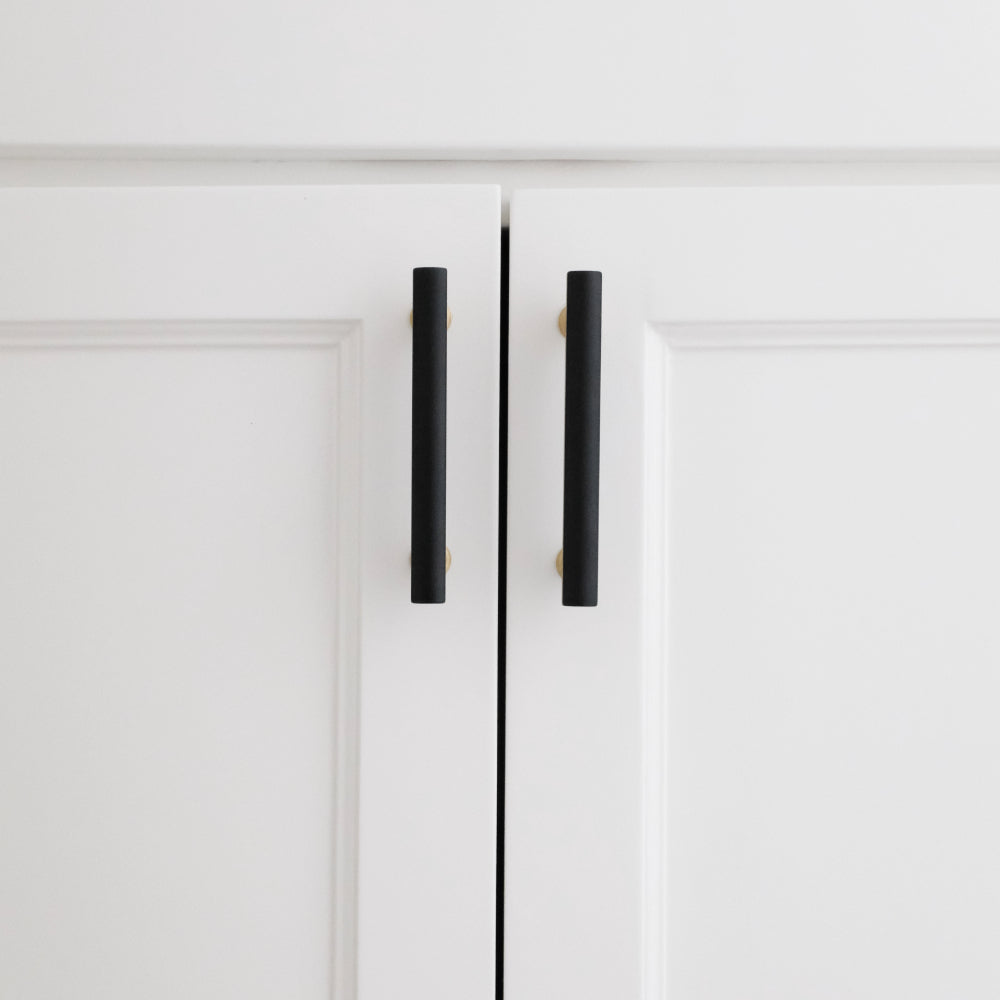 black and brass mod cabinet pulls installed on white cabinets