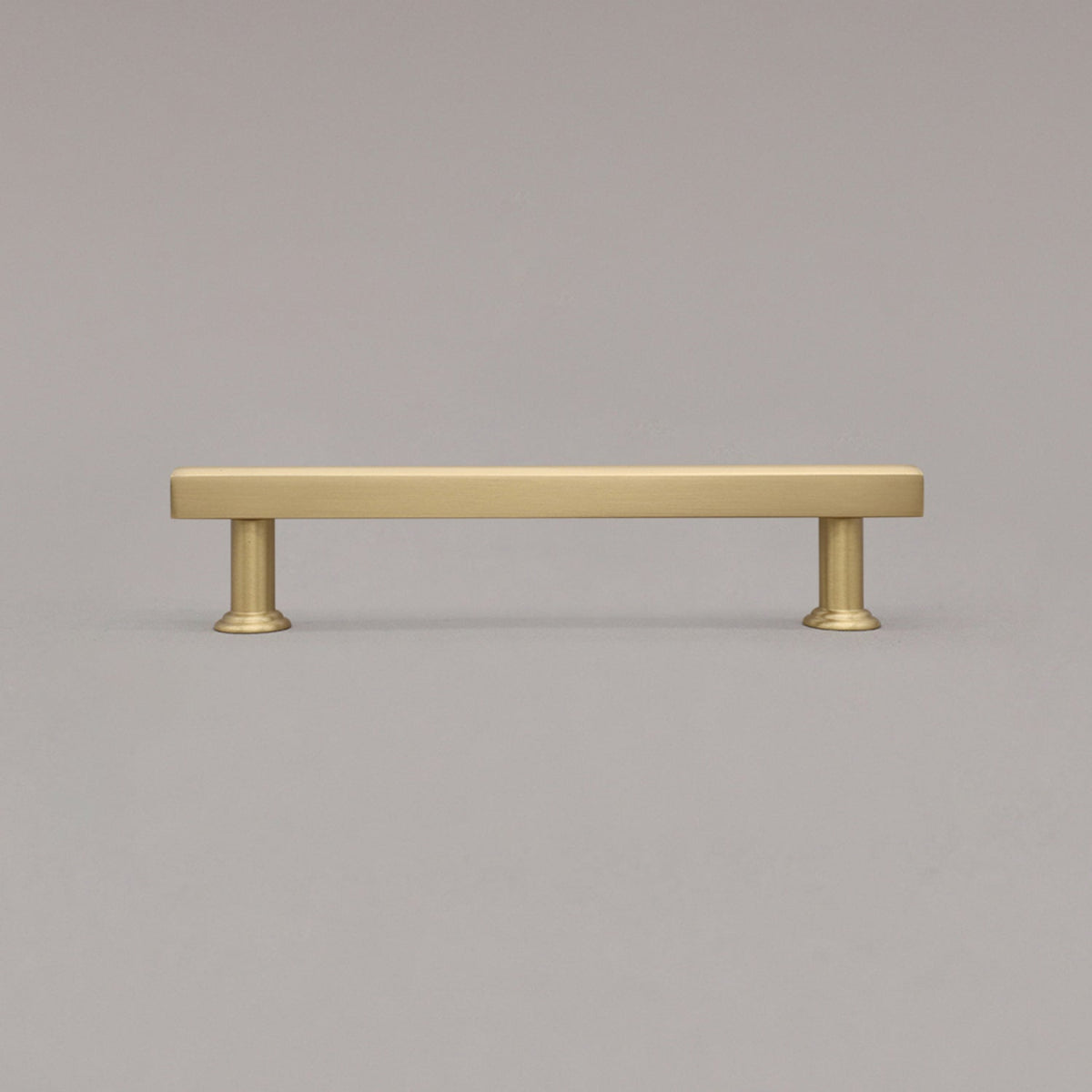 medium satin brass mod cabinet pull standing on gray background