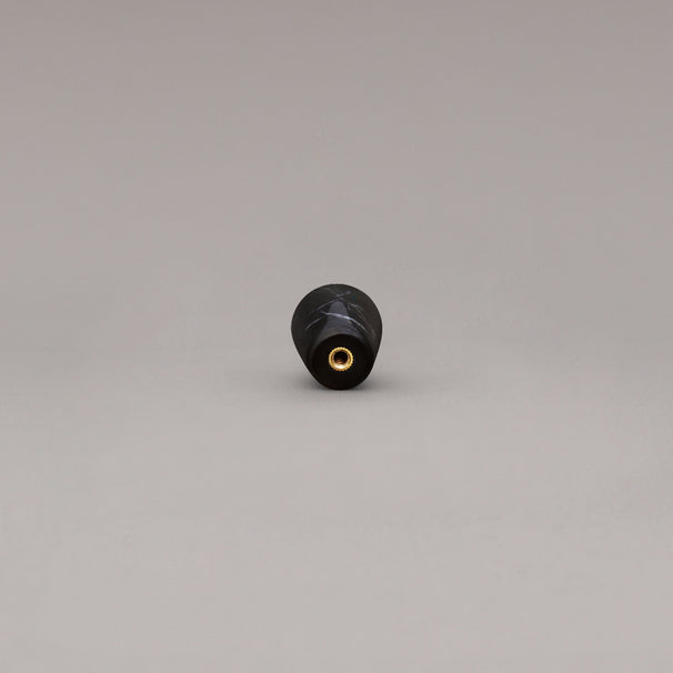rear view of black marble cone knob on gray background