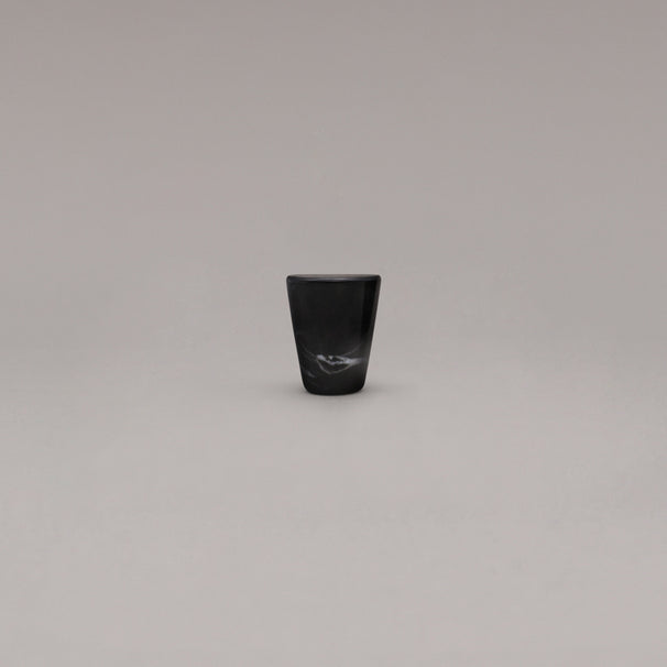 black and white marble cone knob standing on gray background