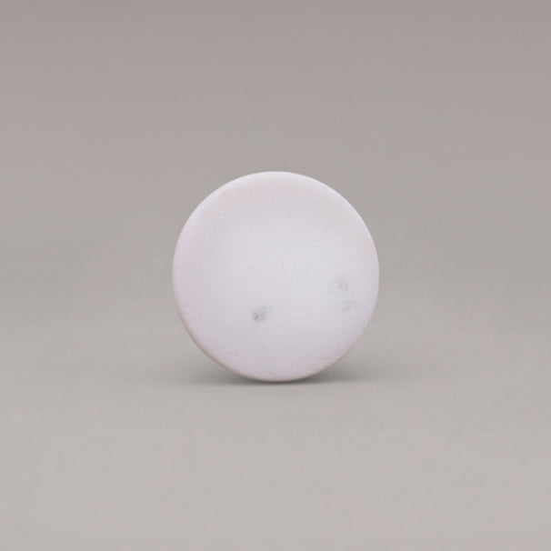 front view of white carrara marble cone knob on gray background