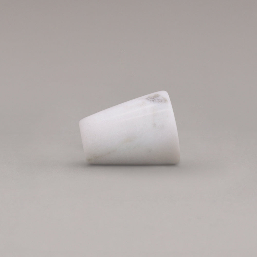 side view of white carrara marble cone knob on gray background