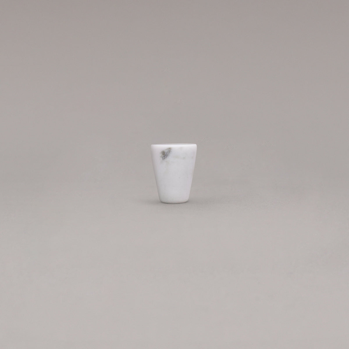 white carrara marble cone knob standing on gray background