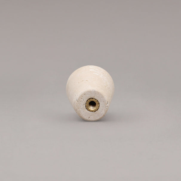 rear view of travertine marble cone knob on gray background