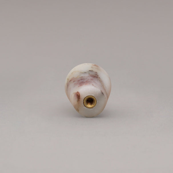 rear view of calacatta viola marble cone knob on gray background