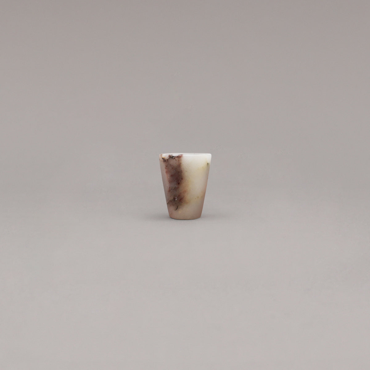 calacatta viola marble cone knob standing on gray background