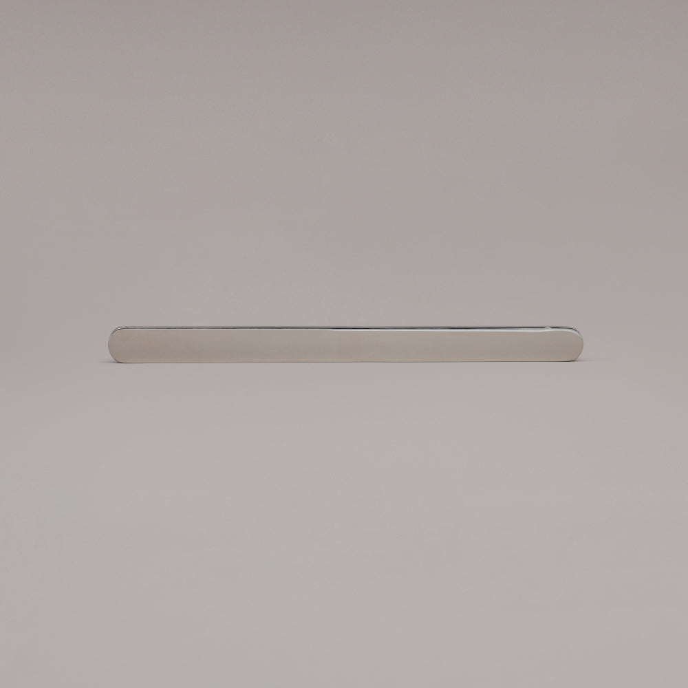 12" Ribbed appliance pull in Polished Nickel laying on gray background