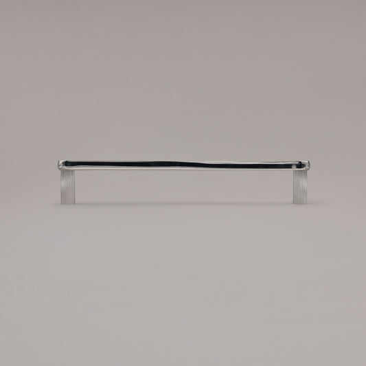 12" Ribbed appliance pull in Matte Black standing on gray background