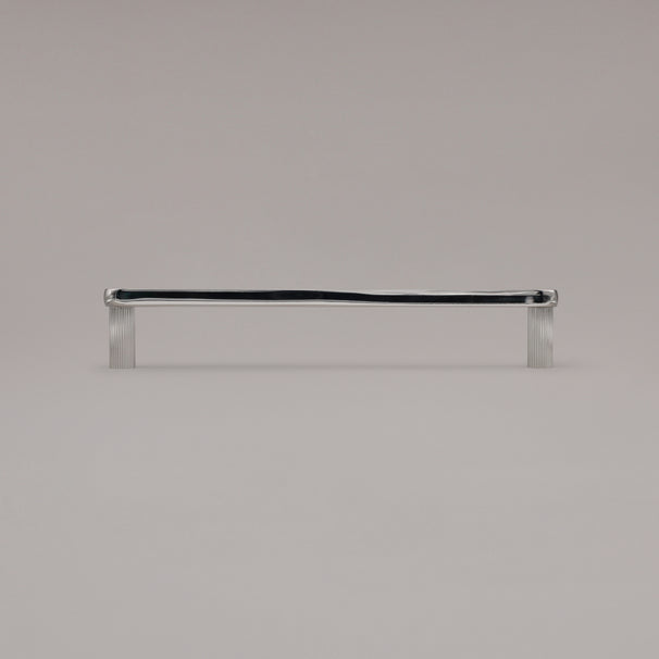 12" Ribbed appliance pull in Polished Nickel standing on gray background