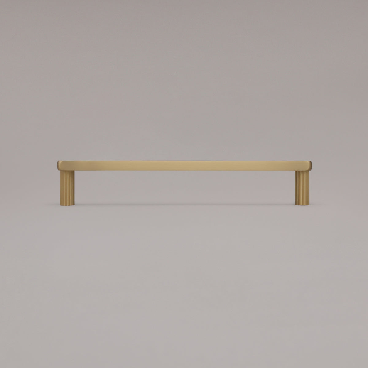 12" Ribbed appliance pull in Satin Brass standing on gray background