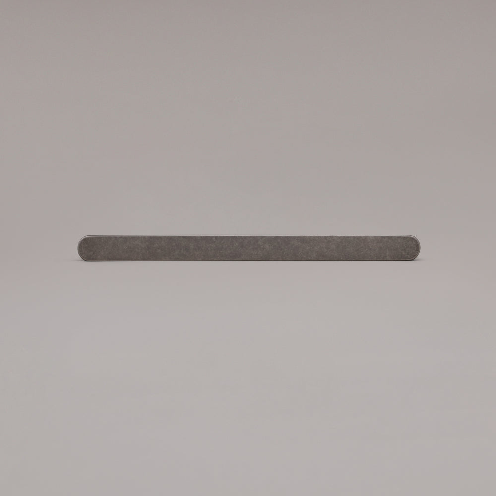 12" Ribbed appliance pull in Weathered Nickel laying on gray background