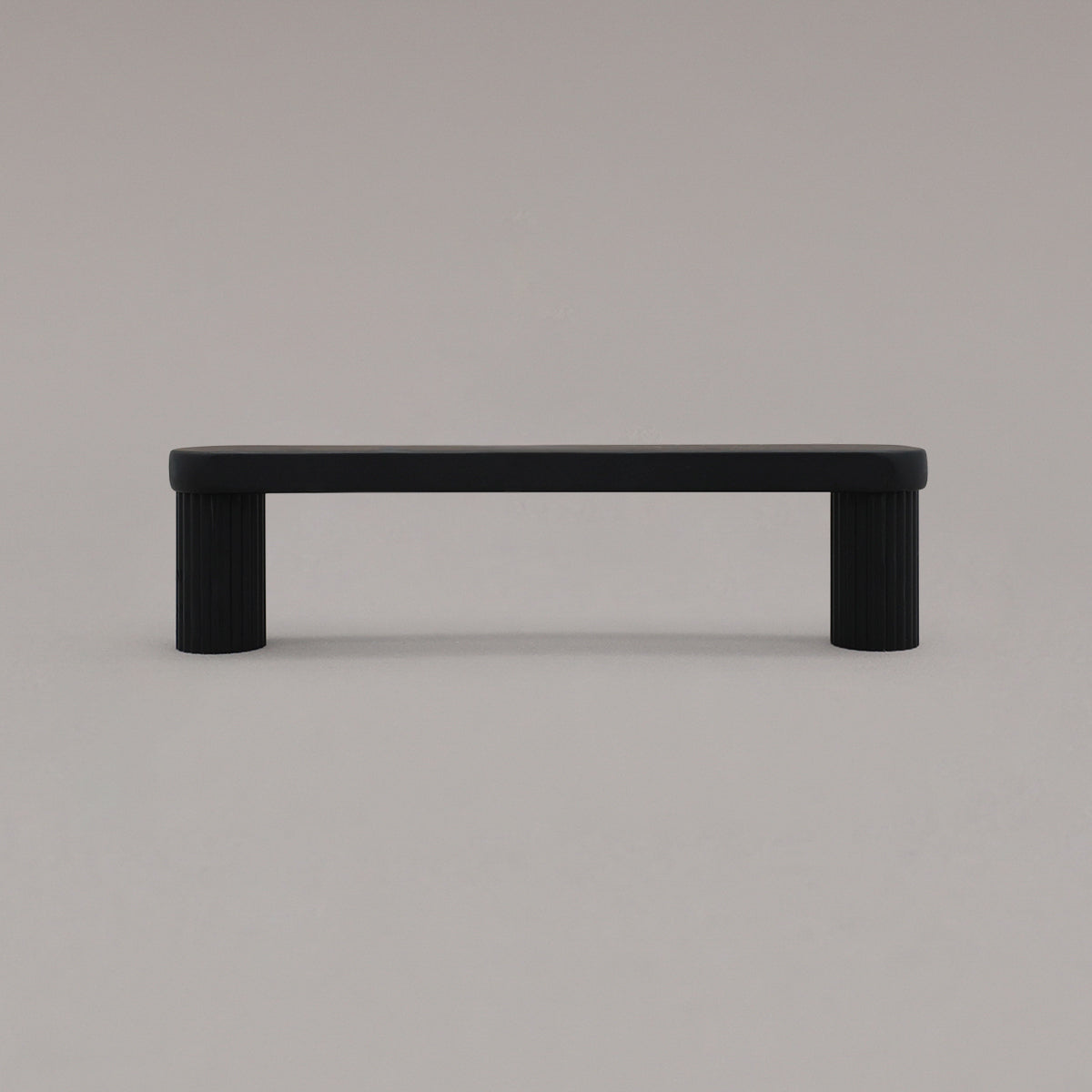 small matte black ribbed pull standing on gray background