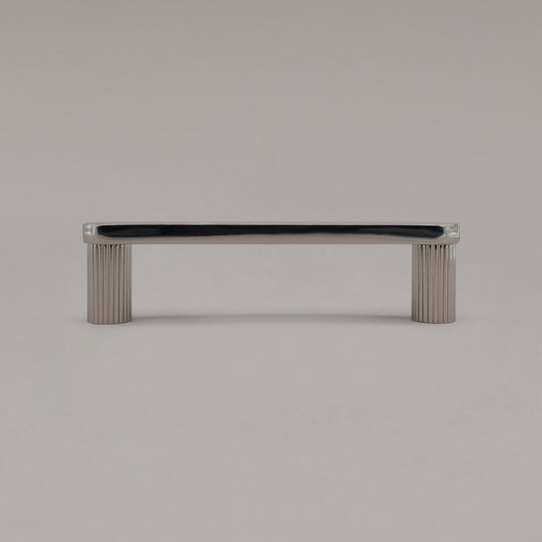 small polished nickel ribbed pull standing on gray background