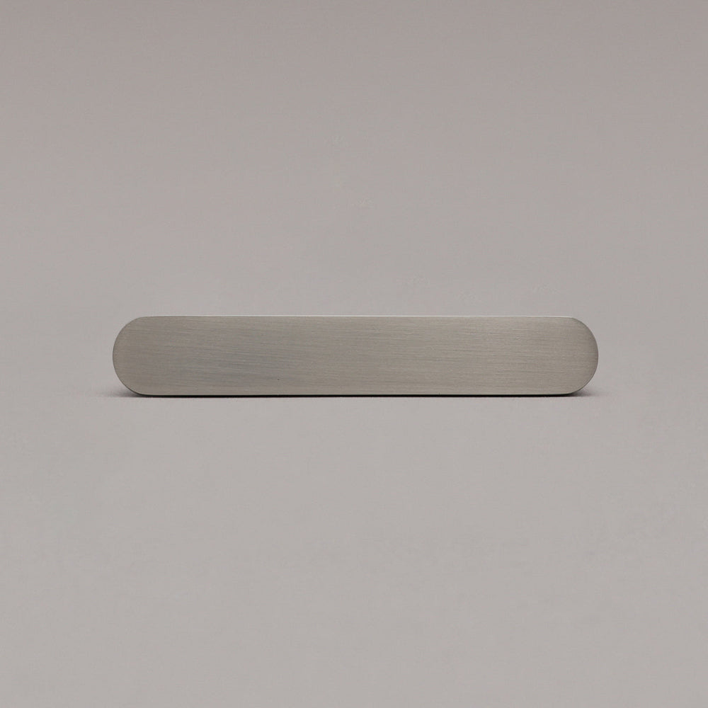 front view of small satin nickel ribbed pull on gray background