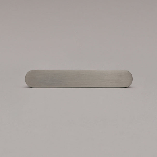 front view of small satin nickel ribbed pull on gray background