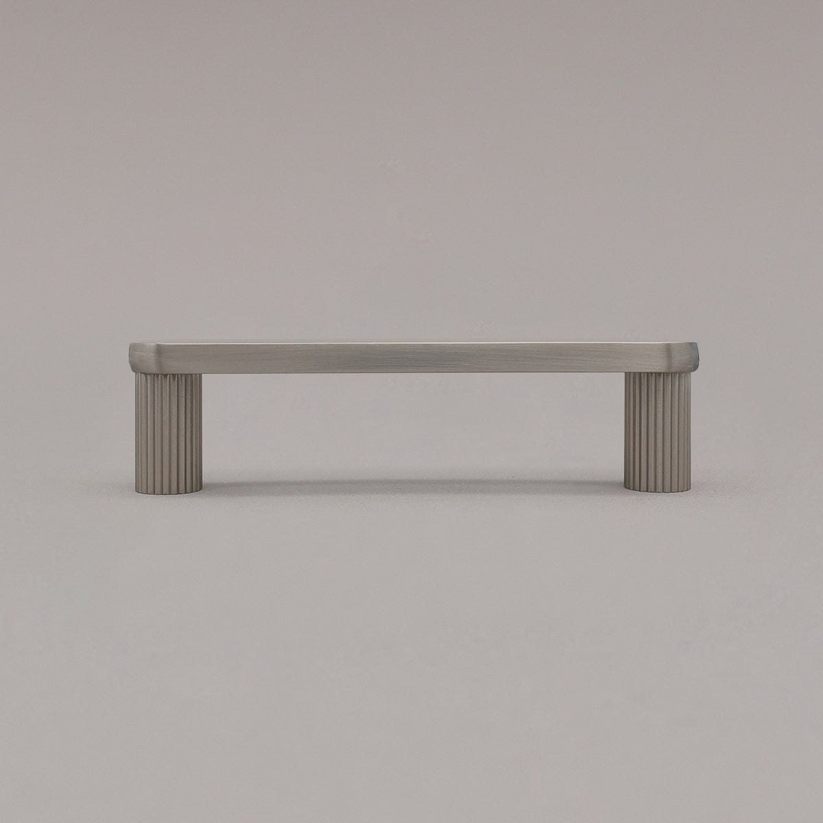 small satin nickel silver ribbed pull standing on gray background