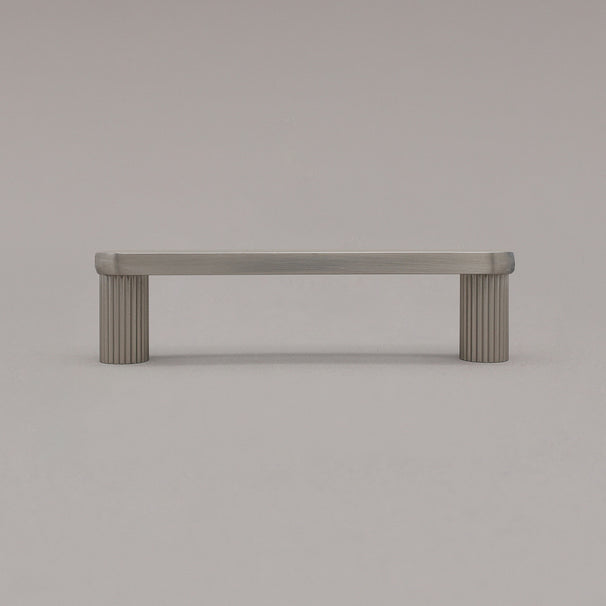 small satin nickel silver ribbed pull standing on gray background