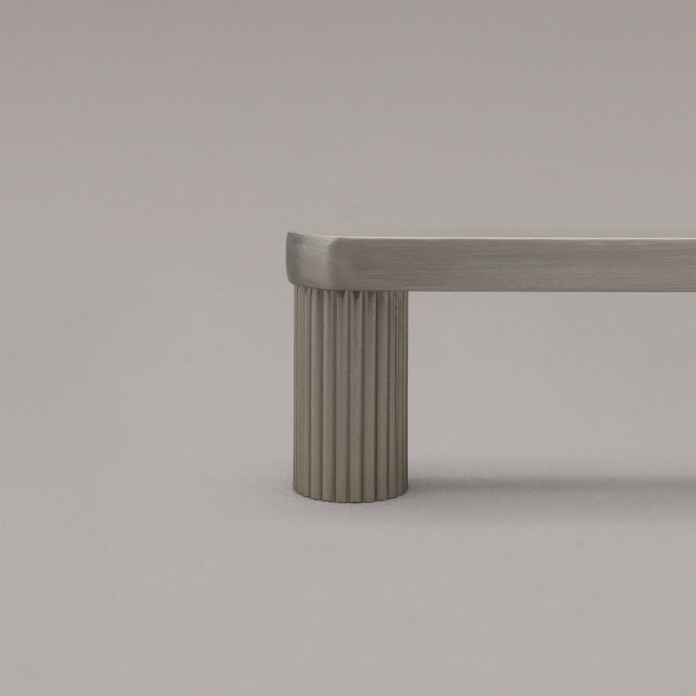 close up of satin nickel ribbed pull stem on gray background