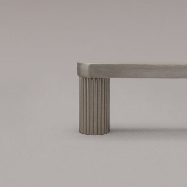 close up of satin nickel ribbed pull stem on gray background