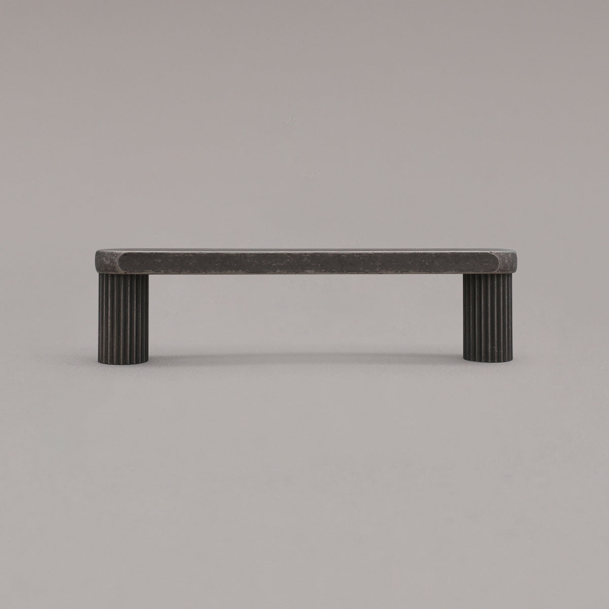 small weathered nickel ribbed pull standing on gray background