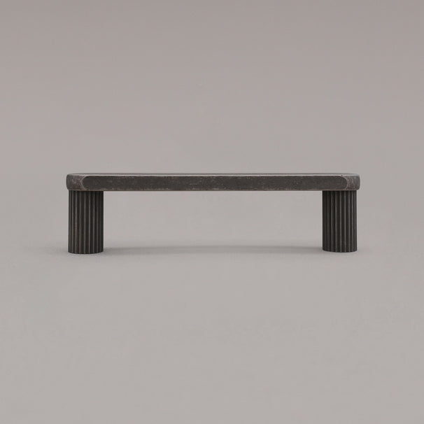 small weathered nickel ribbed pull standing on gray background