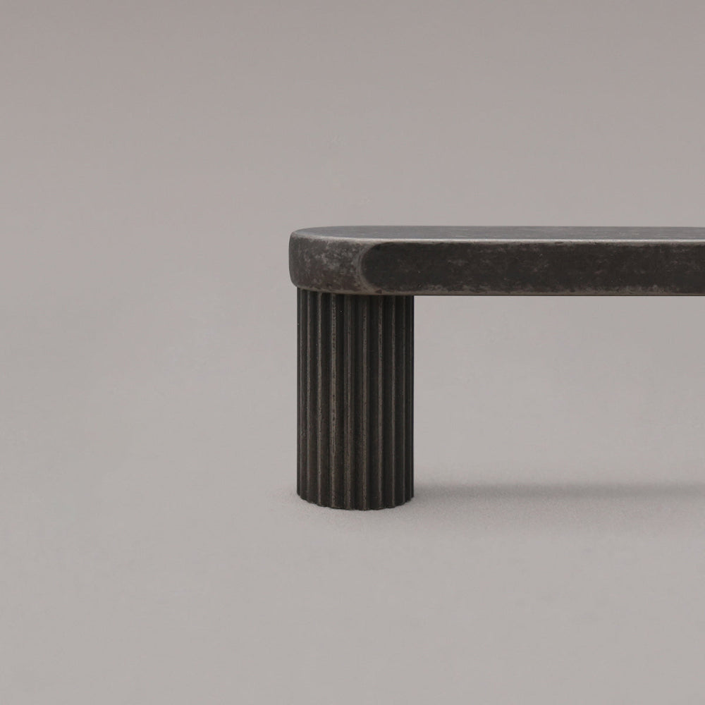 close up of weathered nickel ribbed pull stem on gray background