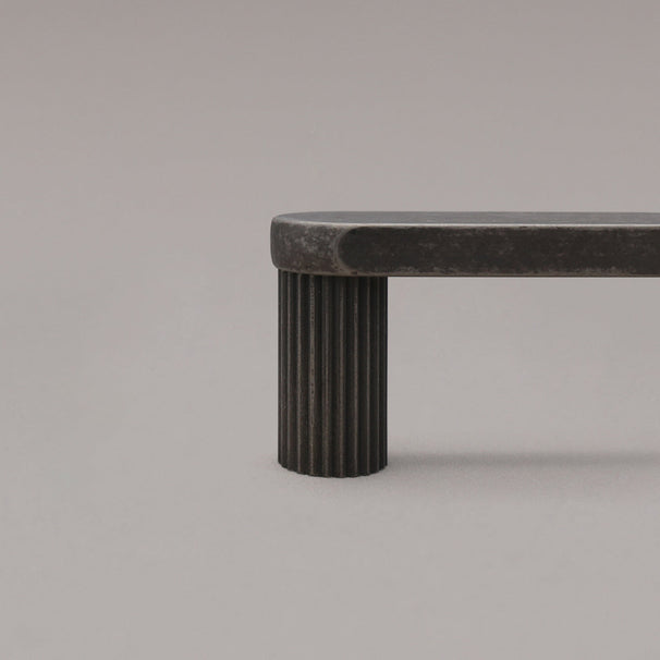 close up of weathered nickel ribbed pull stem on gray background