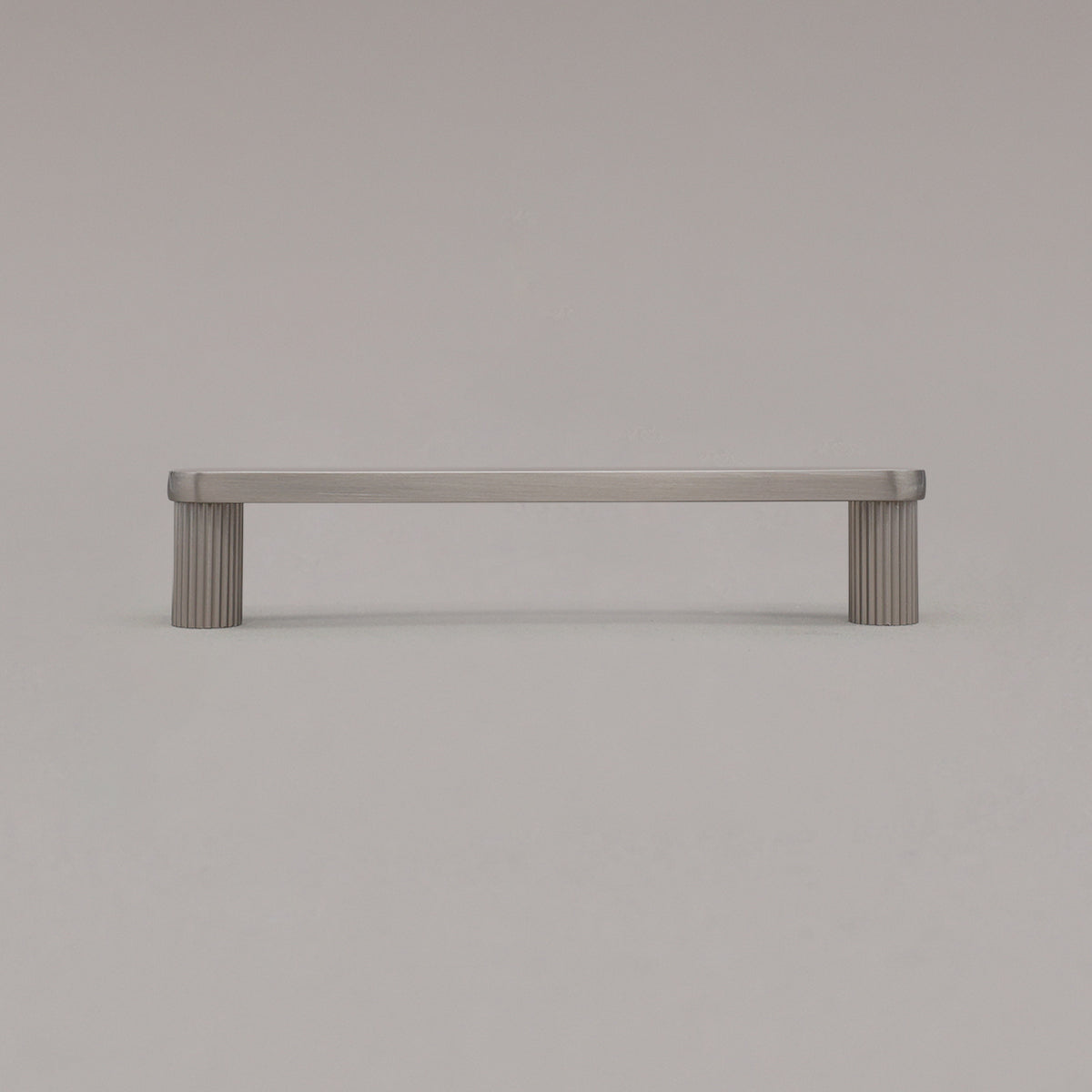 medium satin nickel silver ribbed pull standing on gray background