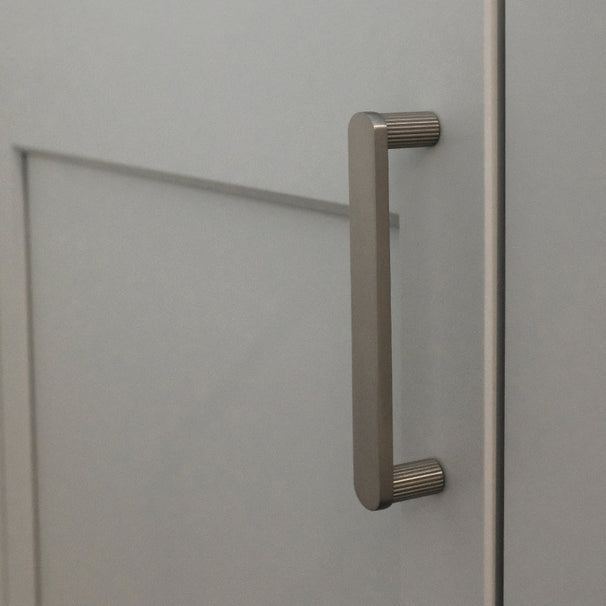 satin nickel pull installed on gray background