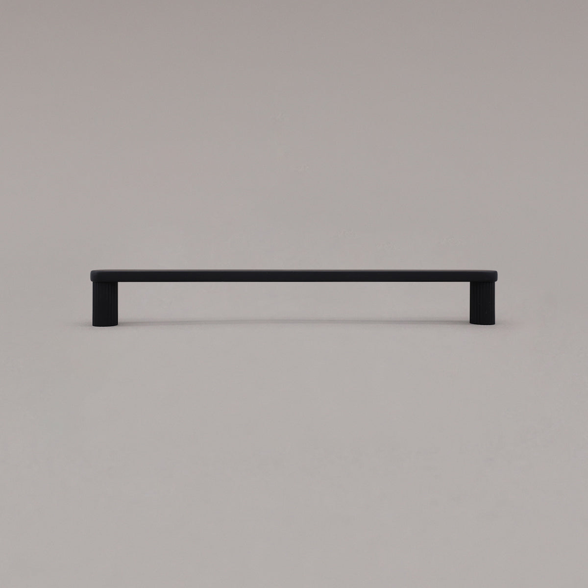 large matte black ribbed pull standing on gray background