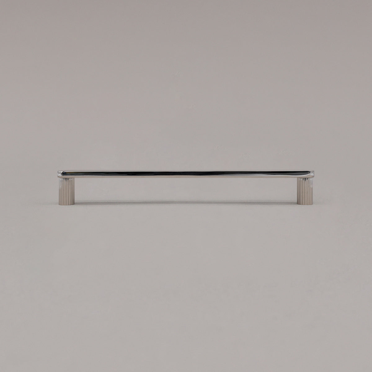 large polished nickel ribbed pull standing on gray background