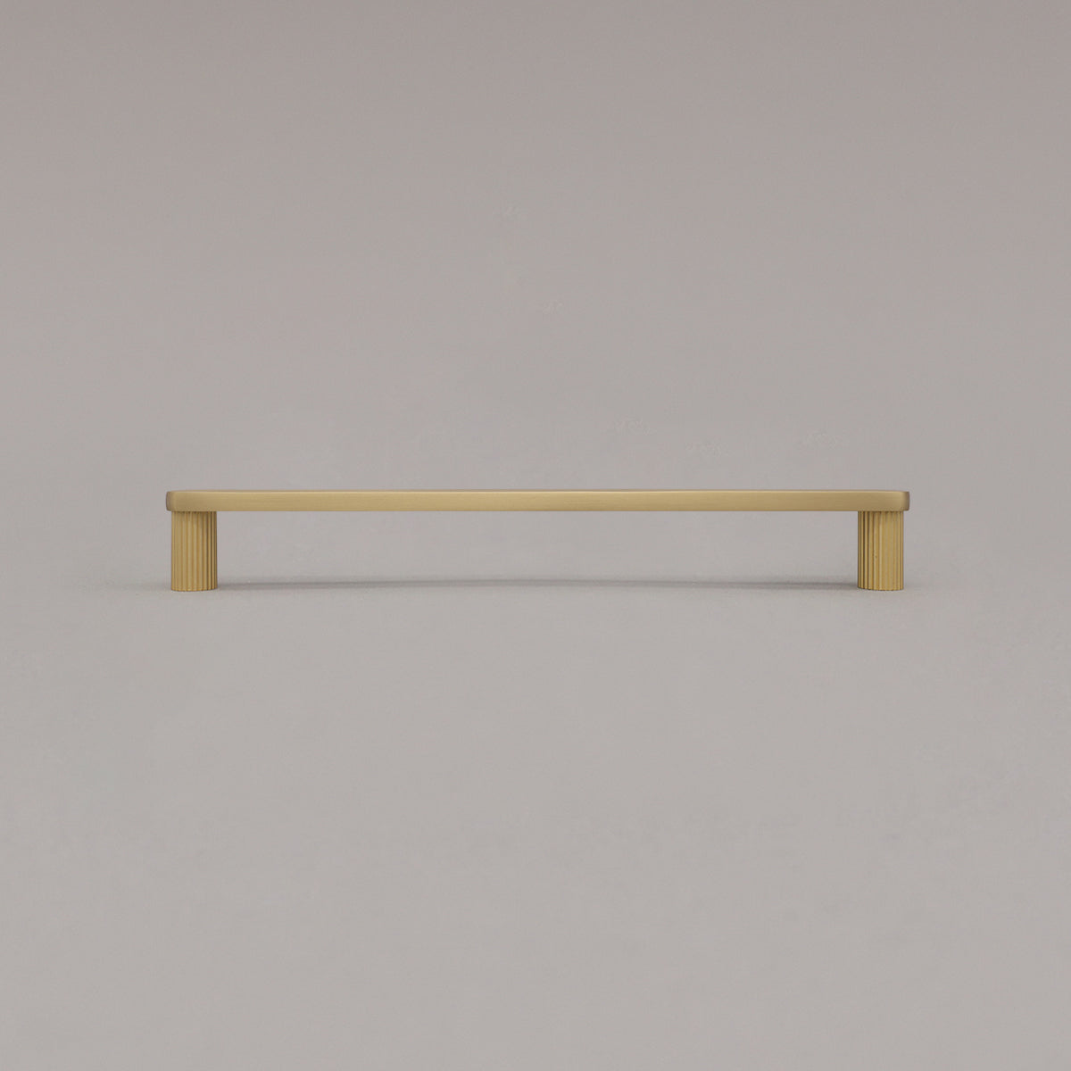 large satin brass gold ribbed pull standing on gray background