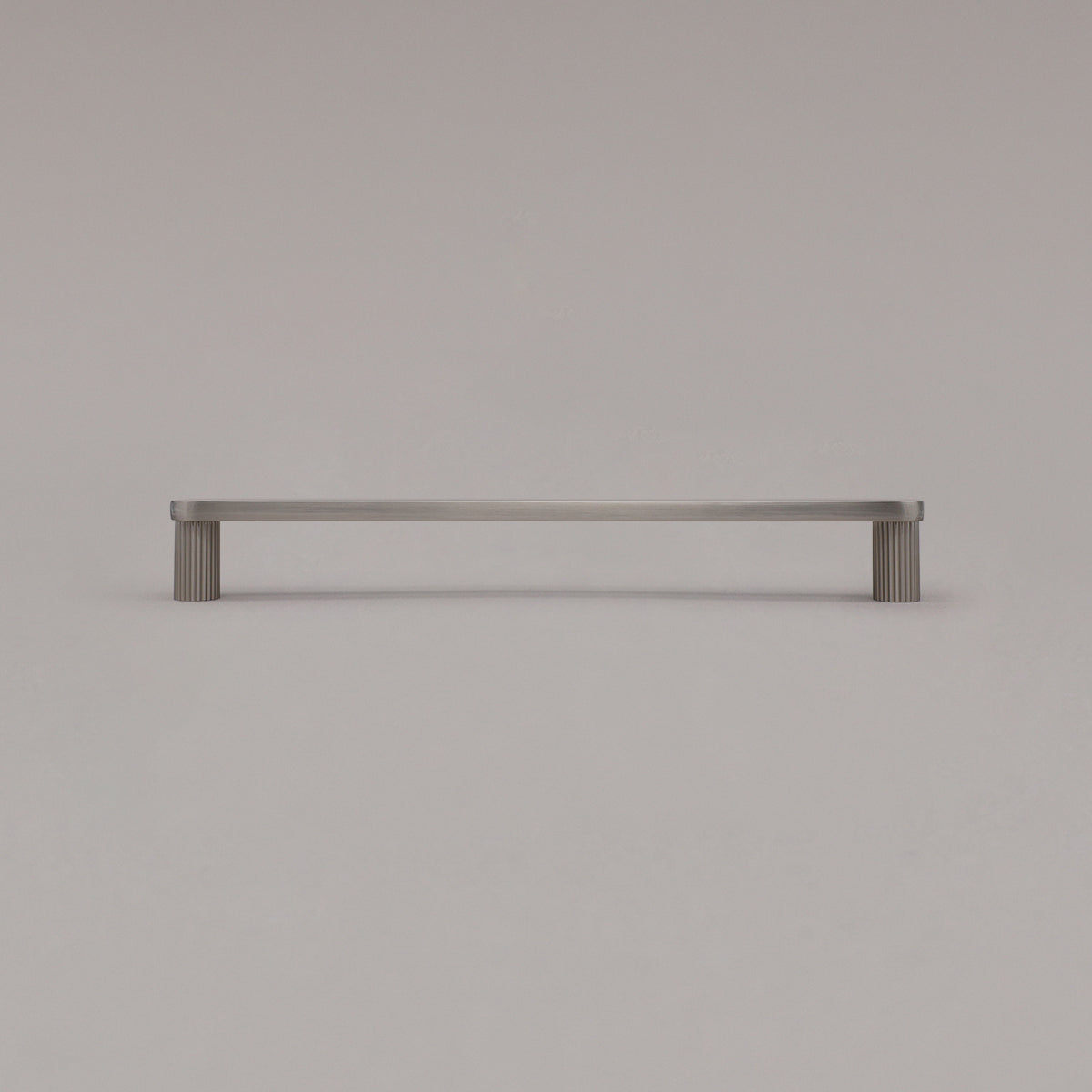large satin nickel silver ribbed pull standing on gray background