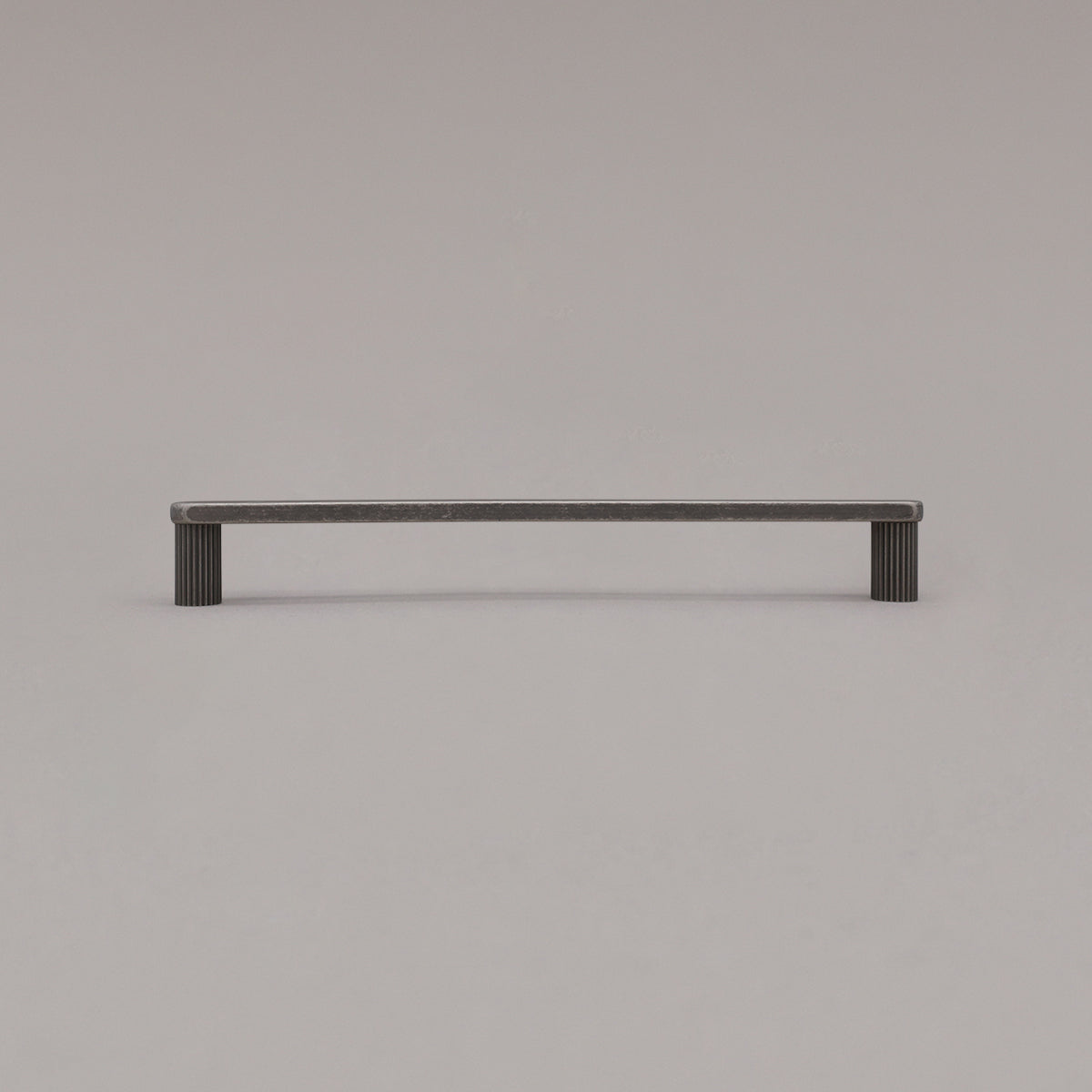 large weathered nickel ribbed pull standing on gray background
