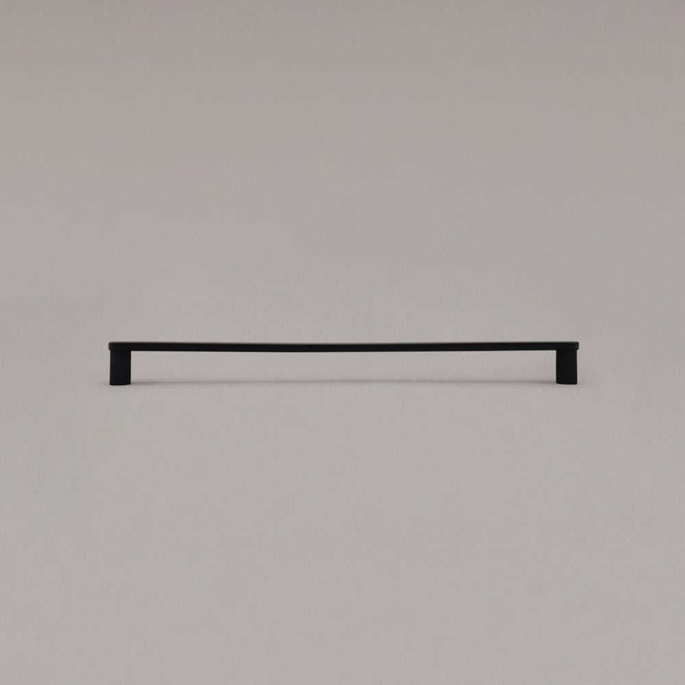 extra large ribbed matte black cabinet pull standing on gray background