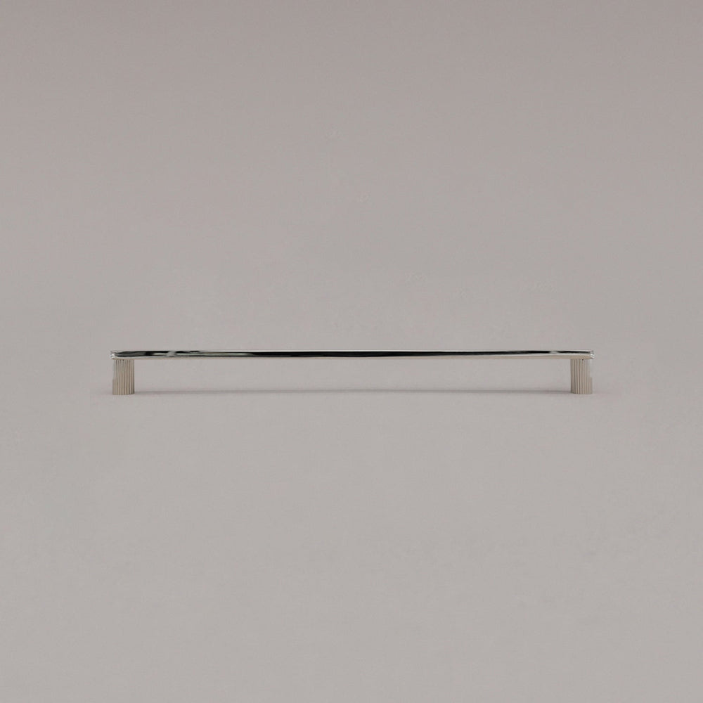 extra large ribbed polished nickel cabinet pull standing on gray background