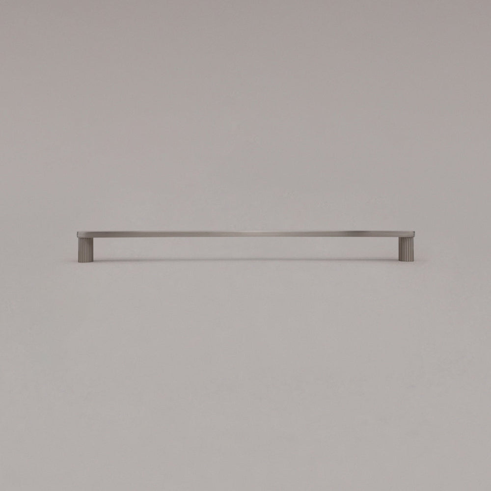 extra large ribbed satin nickel cabinet pull standing on gray background