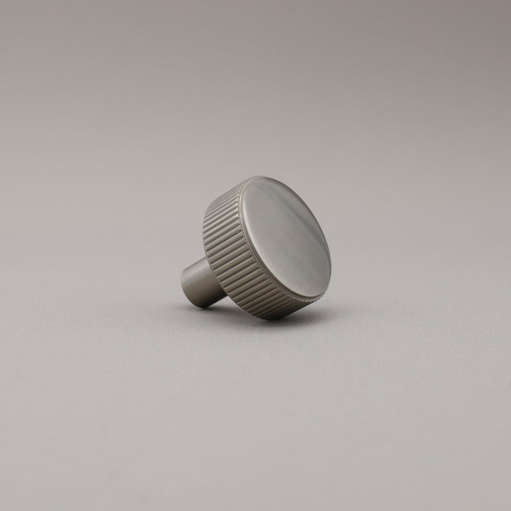 satin nickel silver textured ribbed knob with fluting detail on a gray background